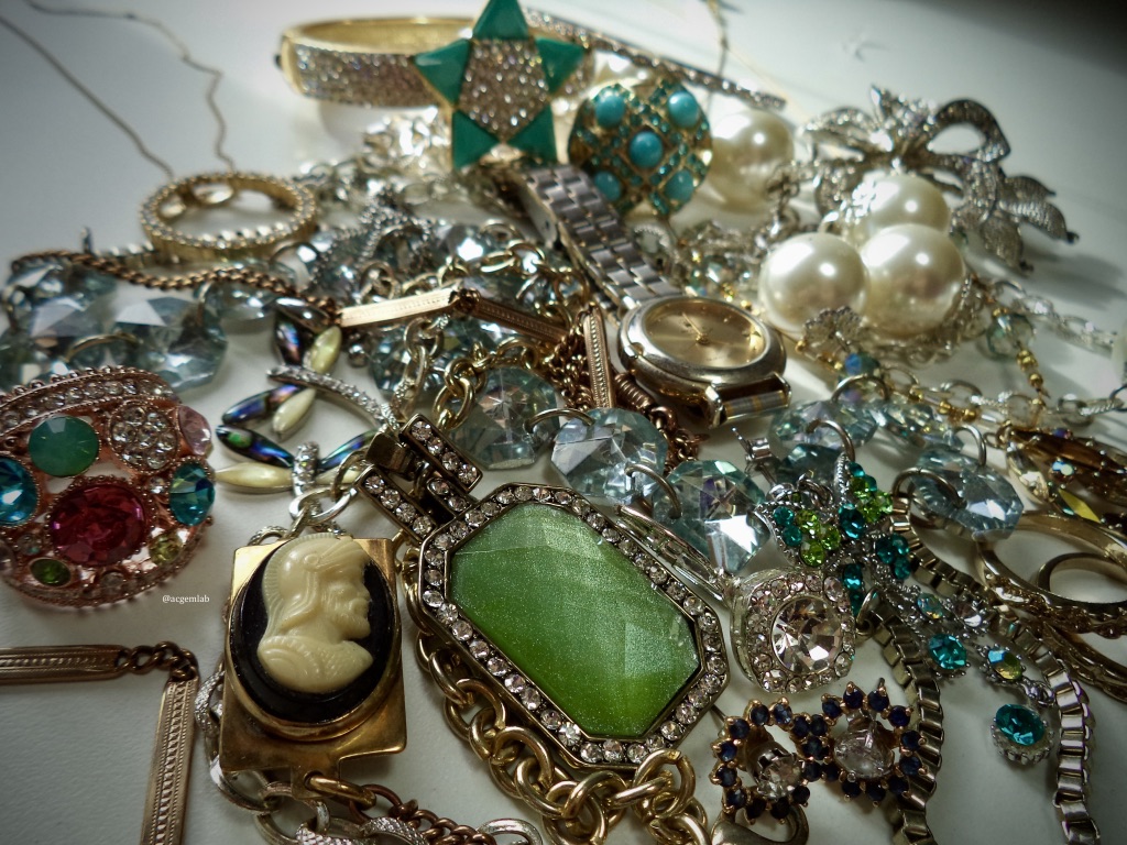 What stories would your jewellery tell? Collection of jewellery laid out on a table.  Photo Credit: @acgemlab